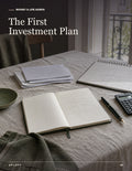 First Investment Plan workbook cover with an open planning journal, notes, pen, and calculator on a table